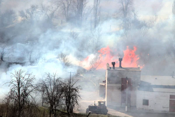 Farm fire. Burning building and agricultural machinery. Fire of non-residential buildings and trees.