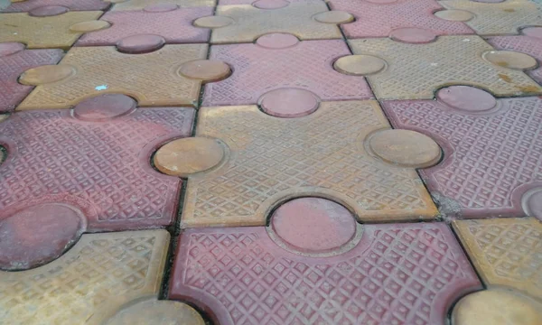 closeup image of 80 mm thick interlocking tile flooring laid outside of an residential building