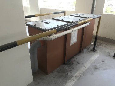 Floor mounted three compartment Grease Interceptors to remove the Oils fats and Adhesive materials from the waste water coming from the Kitchen area before the waste into municipal line clipart