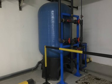 Guarded reverse osmosis plant set up for drinking water supply for an renowned hotel rooms and set up connected with plumbing work for desalination to get purified water clipart