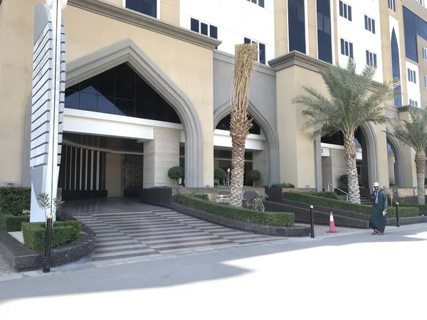 Five star hotel entrance with drive in facility to drop the customers with islamic style front elevation at middle east country with free standing name board