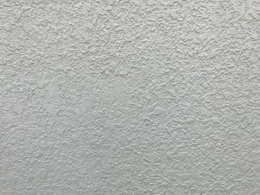 Yüksek katlı binaların dış yüzeyi için krem rengi dış dokusu tozdan ve atmosferden korunmak için birçok dalgalanma ile boyanmış.