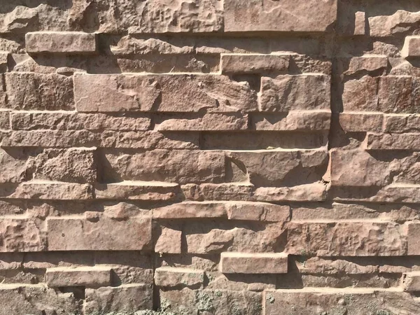 Stone pitching works for wall finishes of compound wall of an Residential villa House