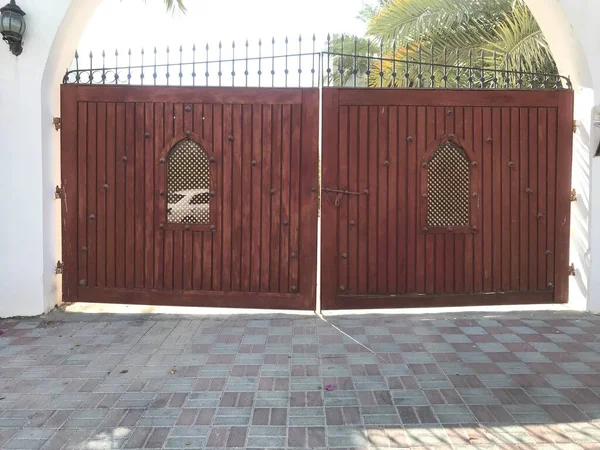 Wooden shutter with Steel Framed Gate for an Big Villa or palace and two holes for identification of personnel