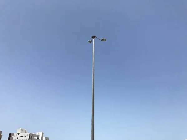 10 meter high Electric light pole carrying two flood lights for better lighting experience for the open car parking and can be designed for the highways car movement of vehicles