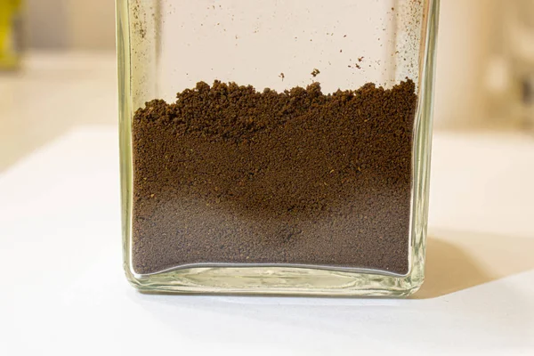 Ground coffee in a glass jar. Close up