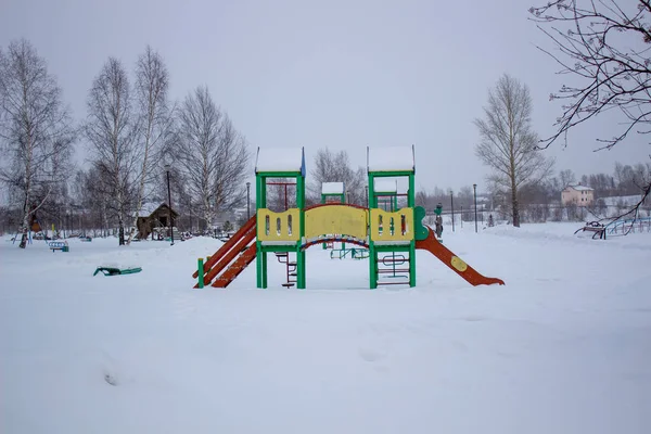 Paths in the winter Park. Bench, Playground for children. — Stock Photo, Image