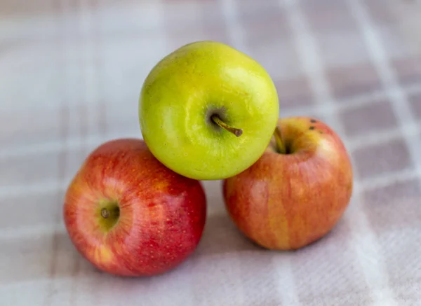 Tři Jablka Jedno Zelené Dvě Červenožluté Světlém Pozadí — Stock fotografie