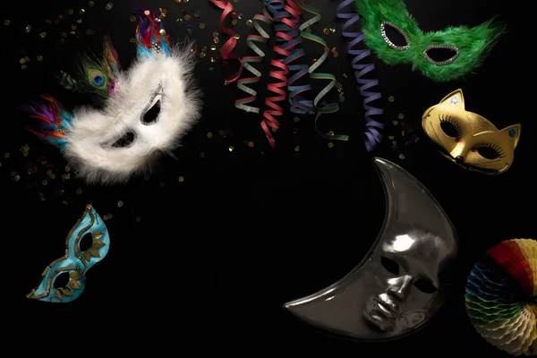 Carnival Objects Black Background Coiled Streamers Masks Confetti — Stock Photo, Image