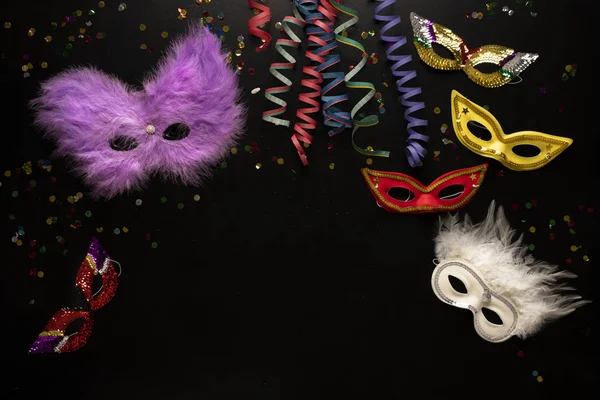 Carnival Objects Black Background Coiled Streamers Masks Confetti — Stock Photo, Image