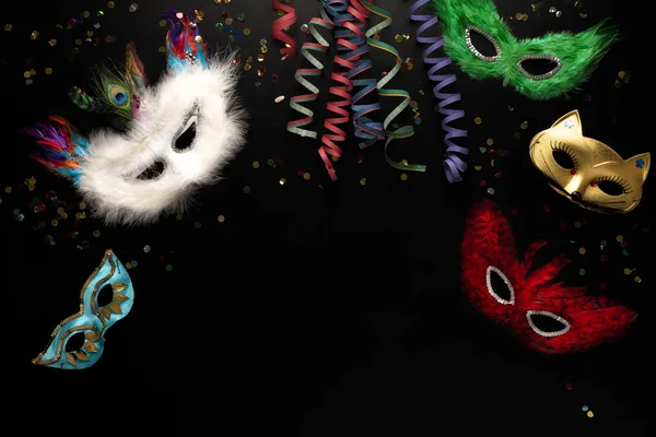 Carnival Objects Black Background Coiled Streamers Masks Hats Confetti Many — Stock Photo, Image