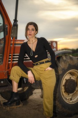 Farm girl on the tractor ready for harvest