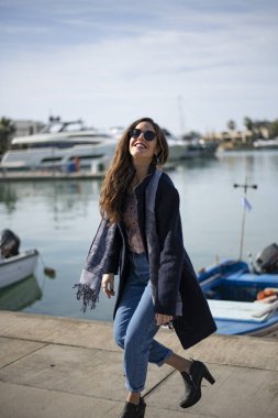 Business woman walks at the harbour