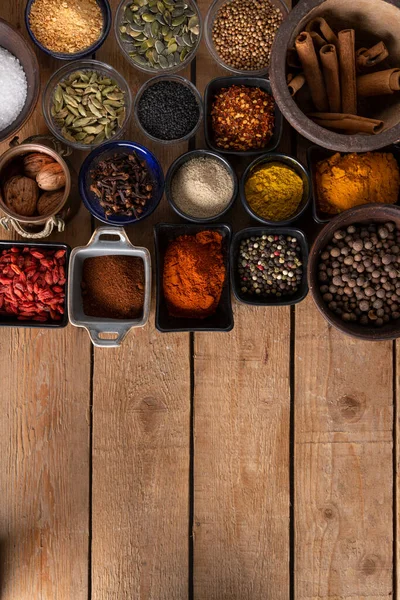 Variety of Spices on a wooden surface with a place for logo