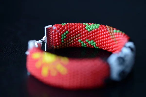 Red beaded bracelet with image of funny panda close up