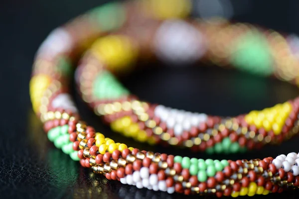 Ethnic style beaded necklace on a dark background close up