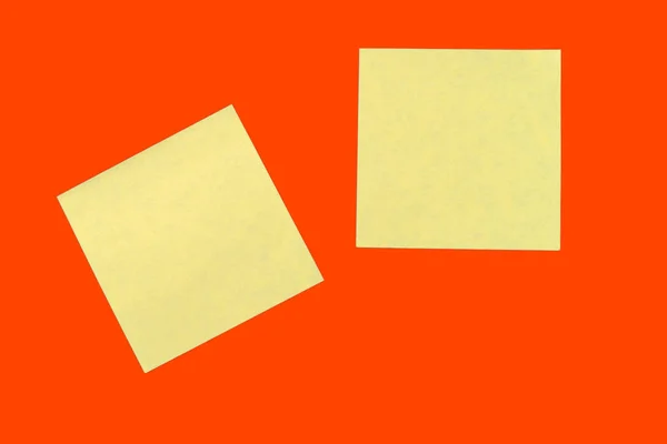 Yellow sticker notes on a bright orange red. Business background, copy space