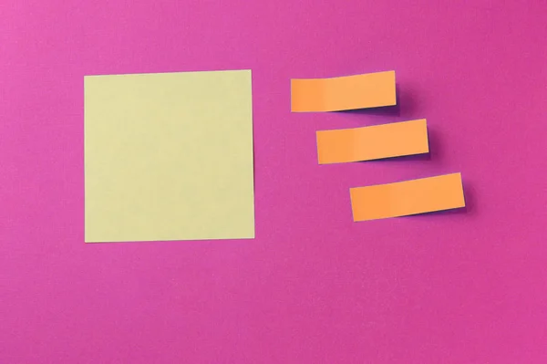 Sticker notes on a bright pink background. Top view, copy space. Business concept, horizontal mock-up