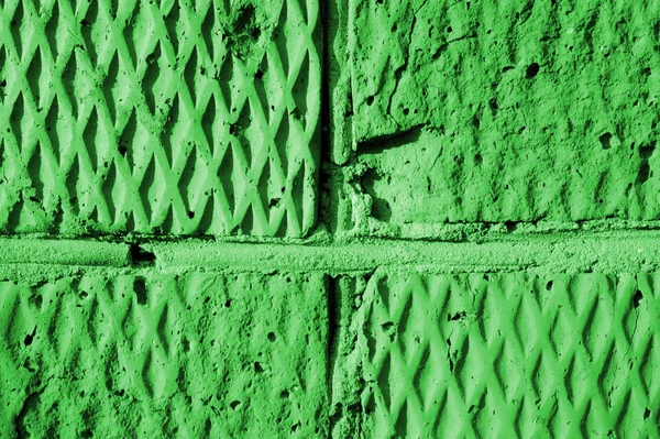 Brick wall texture in sunny day close-up. Abstract background green color toned