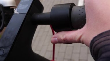 Parmak, elektrikli scooter 'ın gazına basıyor. Makro çekim