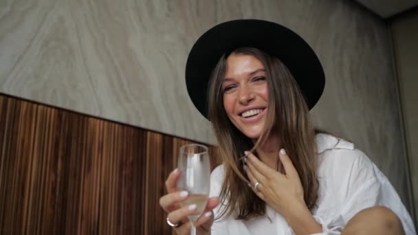 Joyful Young Girl in a Hat with a Glass of Champagne — Stock Video