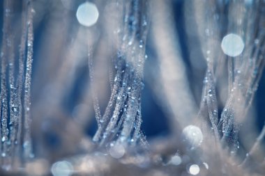 Blurred delicate blue background. Beautiful delicate soft background. Minimalism. Mysterious Christmas defocused background. Festive frame with twinkling bokeh stars. Abstract blurred bokeh curtain.