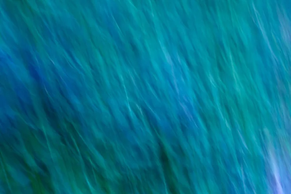 軟らかい青と緑の柔らかい波で背景がぼやけている。波の動き効果を持つ青緑の背景。概念の海海空 — ストック写真