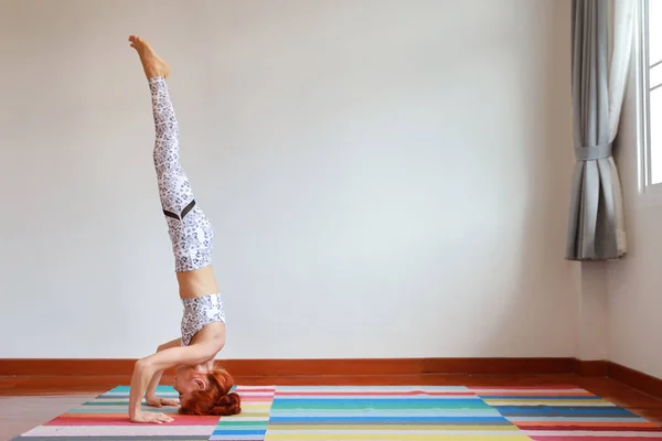 Sporty young attractive caucasian woman in black and white sportswear practicing or exercise yoga indoor. balance between body and mental. (healthy life concept) — Stock Photo, Image