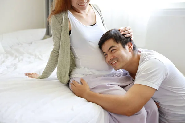 Handsome caucasian husband listening his asian pregnant belly wife with happy smile face and love — Stock Photo, Image