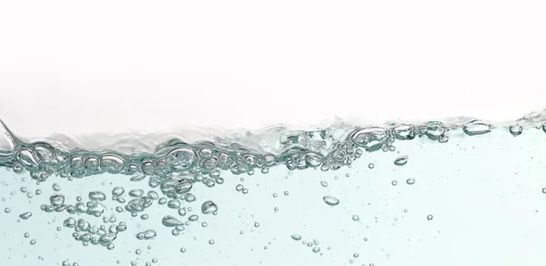Close up blue water splash with air bubbles. Fresh and clean surface aqua flowing in wave and clean water on white background isolated. Advertising image with free space for your work — Stock Photo, Image