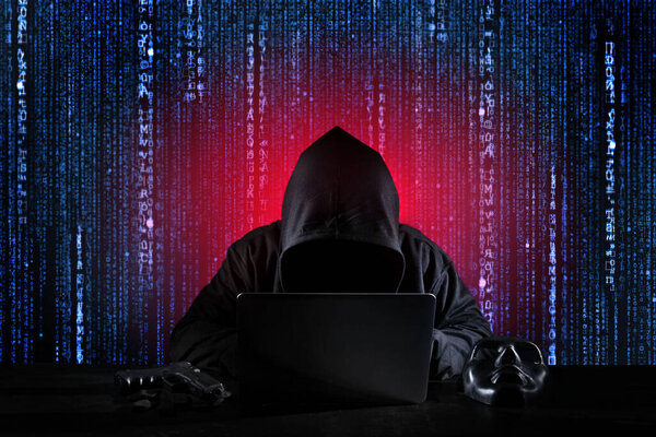 Dangerous hacker man in black hooded, masked and gun using computer, breaking into security data and corporate server. He stealing payment information as binary code. Concept of cyber attack security