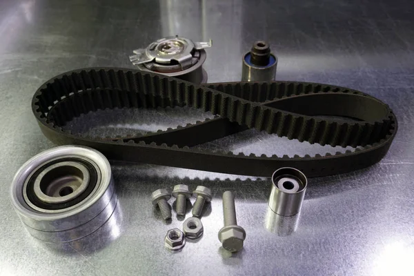 Repair kit for replacing the timing belt. The kit consists of a timing belt, a tension roller, a bypass roller, a set of fasteners. Spare parts for the repair of a modern car.