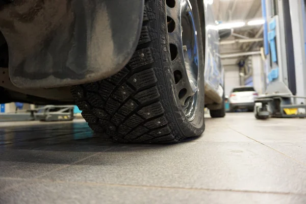 Flat tire on a car in service. Driving a flat tire is extremely dangerous.
