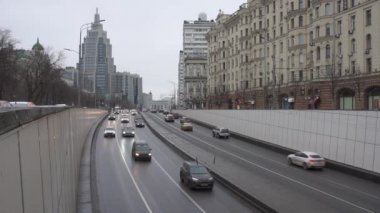 Moscow/Russia-February 02 2020:The movement of cars on Sadovo-Triumfalnaya street. Cars enter and exit the Mayakovsky tunnel. In the background is a high-rise building of the Oruzheyny business center