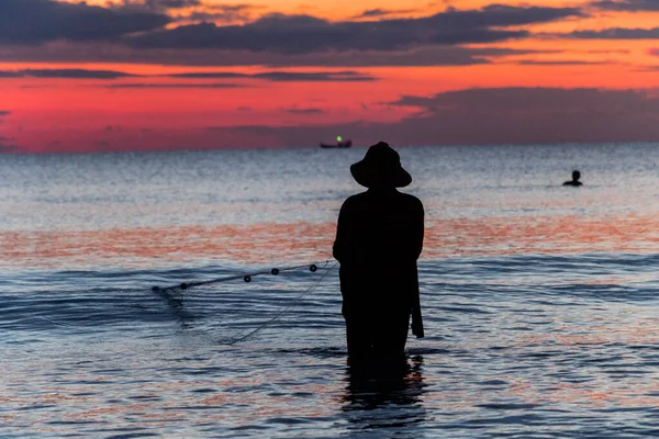 A fisherman is fishing at Sunset on Koh Rong, Cambodia — Stock Photo, Image