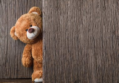 Cute teddy bears on old wood background clipart