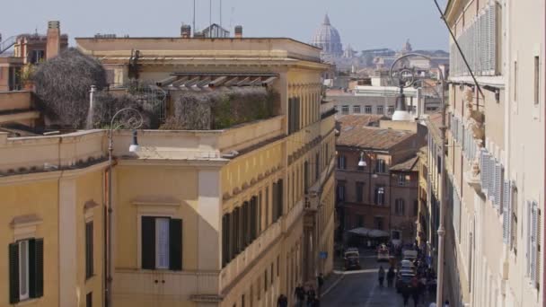 Looking down on a little street in Rome, where you can also see St Peters Basilica in the background — Stock Video