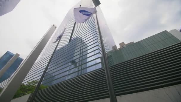 Blick nach oben auf die samsung-Flaggen, die im samsung-Hauptquartier in seoul wehen — Stockvideo