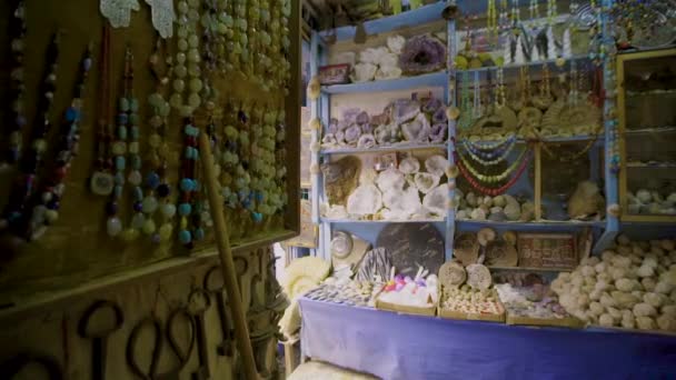 Handheld shot tracking towards fossils and gemstones in a Moroccan shop — Stock Video