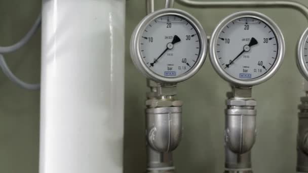 Tracking shot past a row of pressure gauges — Stock Video