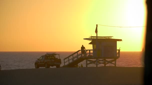 Redder loopt over de helling van een hut op Venice Beach, La bij zonsondergang — Stockvideo