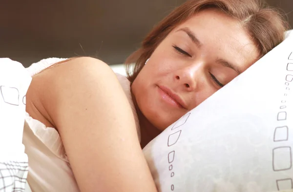 Closeup portrait of a cute young woman sleeping on the bed — Stock Photo, Image