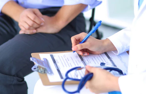 Doctor woman sitting with male patient at the desk