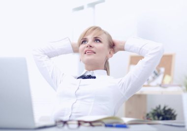 Ellerini başının arkasına ile rahatlatıcı ve bir sandalyede oturan iş kadını