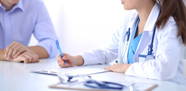 Portrait of young female doctor sitting at desk in hospital — Stock Photo, Image