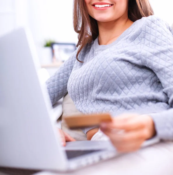 Beautiful smiling woman with laptop and a credit card Royalty Free Stock Images