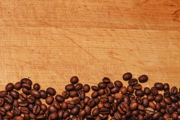 The coffee beans on old table — Stock Photo, Image