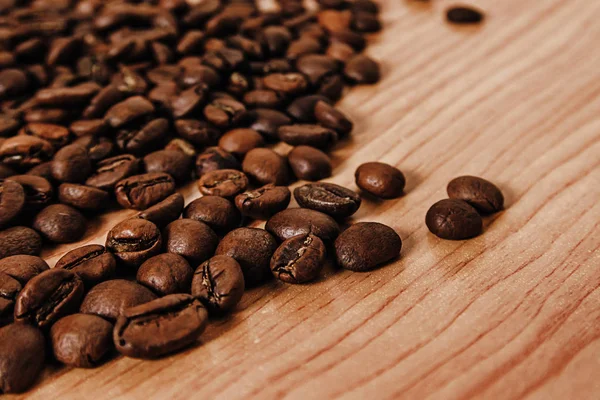 The coffee beans on old table — Stock Photo, Image