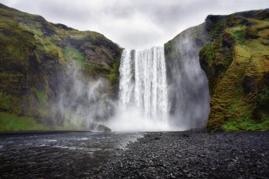 The view of amazing Skgafoss waterfall in Iceland in a dark rainy day