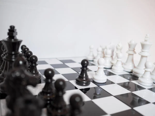 Black and white chess-Army are standing on a board with white background, challenges planning business strategy to success concept — Stock Photo, Image
